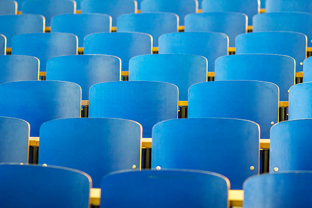 Empty rows of blue chairs in the auditorium of the theater, the auditorium of the theater in blue and green tones.