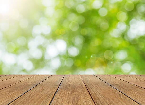 istock bright spring and sunlight bokeh background and perspective wooden plank 492752750