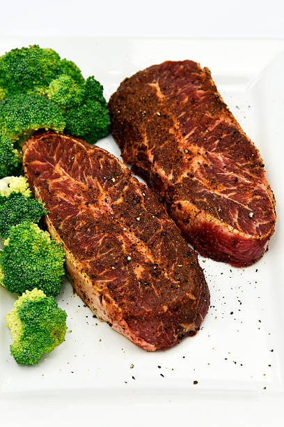 Beef Flat Iron Steak Raw grass fed beef steaks ready to cook broccoli crowns stock pictures, royalty-free photos & images