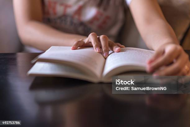 Woman Hand On The Opened Book Stock Photo - Download Image Now - Book, Reading - England, Women