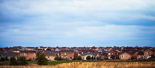 istock USA residential scene with many homes under cloudy blue sky 492754210