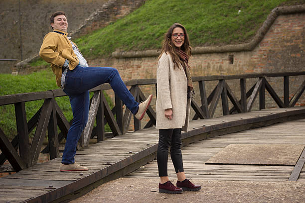 Boyfriend Kicking Girlfriend In Back Prank Funny Shot Stock Photo -  Download Image Now - iStock