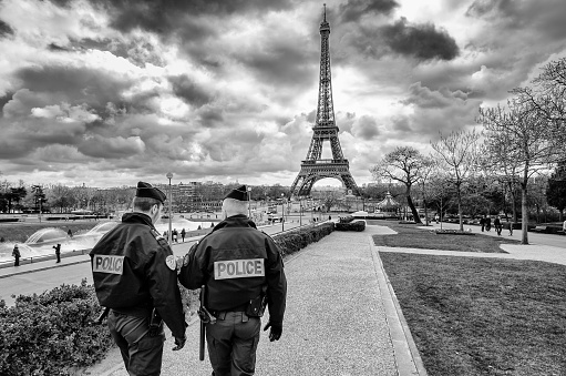 Paris, France - March 18, 2012:  Patrols of two police officers in the Trocadero gardens and Eiffel Tower.