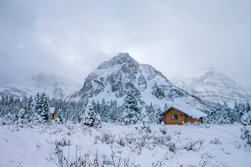 beautiful cabins in the Rocky Mountains of Canada. Snow covered the ground.