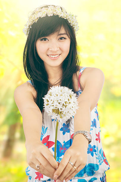istock Girl giving a dandelion on the camera 492757256