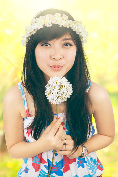 istock Young girl blowing a dandelion in nature 492757274