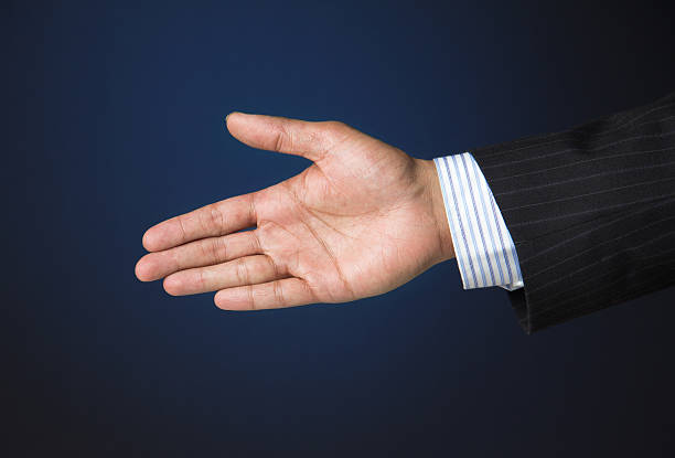 istock Business executive extending arm to shake hands 492757956