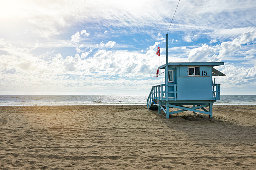 This is a photograph of a closed wooden lifeguard hut Cocoa Beach, Florida on an overcast day before a rain storm.