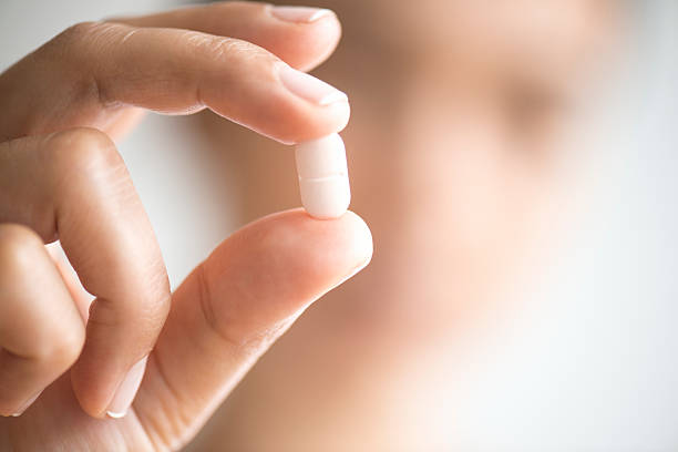 istock Woman Holding And Showing Medication Capsule 492759848