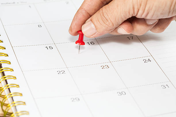 istock Hand push a pin mark on calendar 492762836