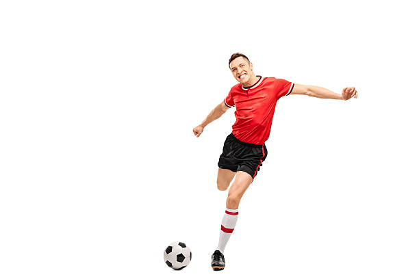 istock Young football player kicking a ball 492764508