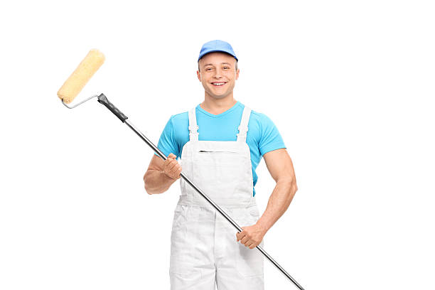 istock Young male decorator holding a paint roller 492764808
