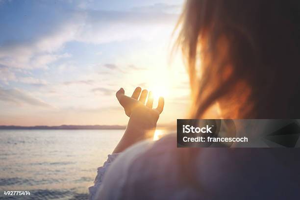 Woman Try To Grab The Sun Stock Photo - Download Image Now - Hope - Concept, Women, The Way Forward