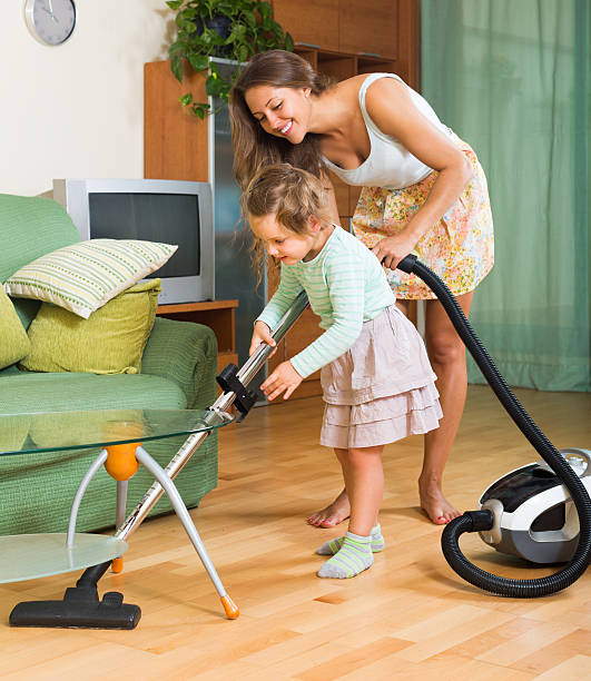 istock Family with vacuum cleaner 492776774