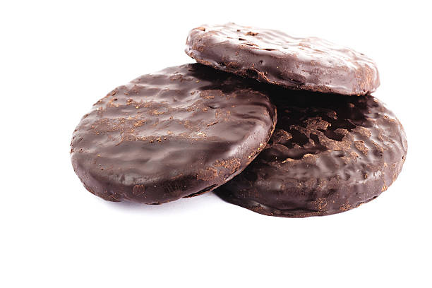istock Three sweet chocolate cookies isolated on white background 492777224