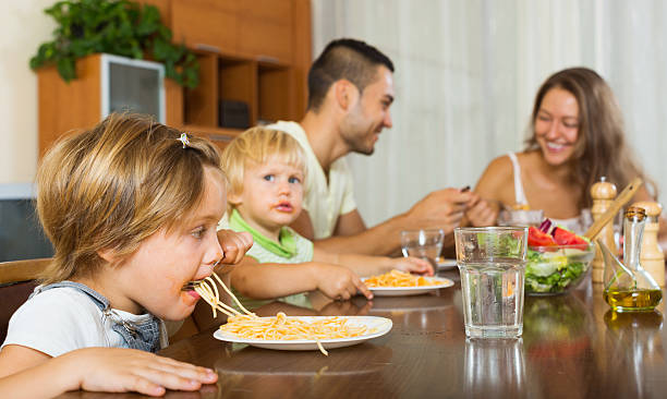 istock family of four  having  pasta 492777448