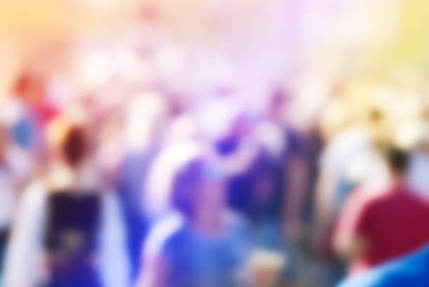 Abstract blur audience crowd of people at public outdoors place or gathering, social event background, vivid colors, defocus image.
