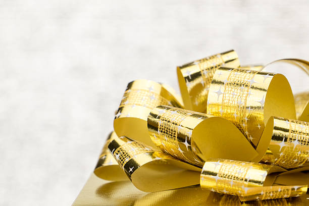 istock Close up Golden present with big bow at bokeh blur 492783226
