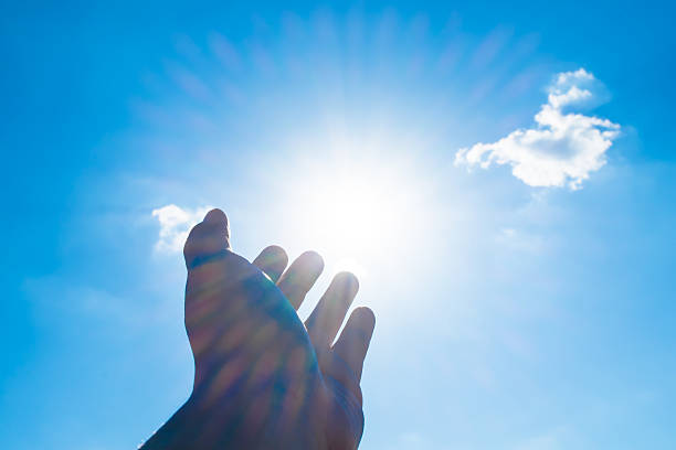 istock Open hand point to sun at blue sky and cloud 492783750