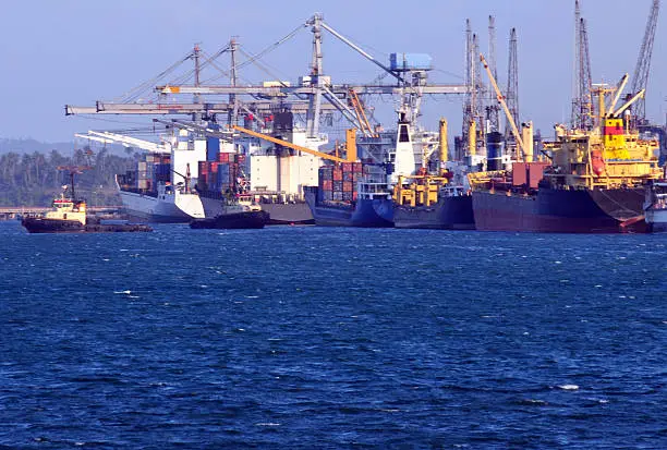 Freighter ships and harbor cranes at the Port of Dar Es Salaam, Tanzania - the fourth largest port on the African continent's Indian Ocean coastline - operated by the Tanzania Ports Authority