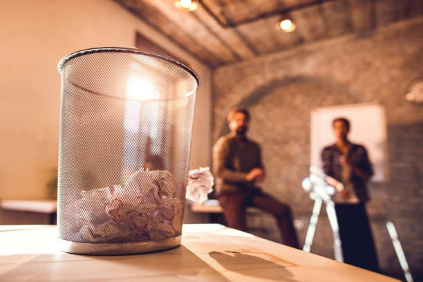 istock Tossing crumpled papers in wastepaper basket. 492785160