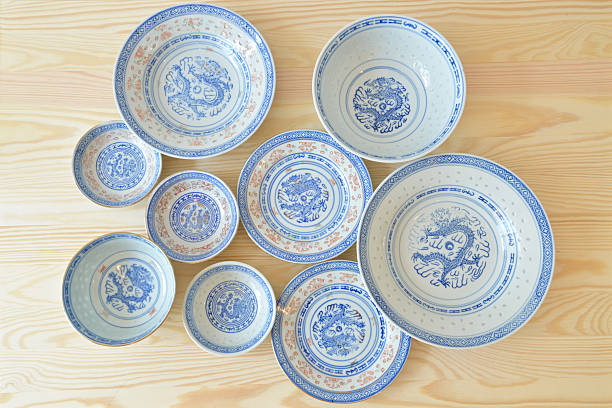 Chinese vintage style blue and white dishes, plate and bowl on the cupboard at home (top view).