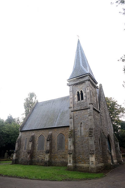istock Abandoned church in cemetery surrounded by gravestones. 492786188