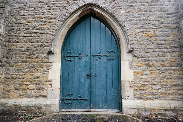istock Abandoned church in cemetery surrounded by gravestones. 492786274