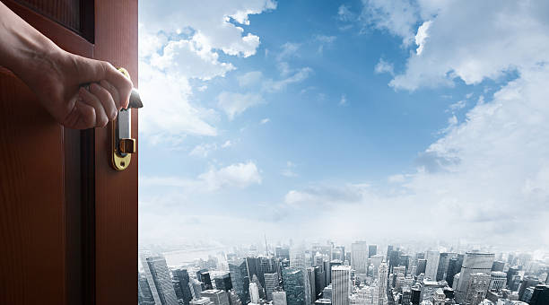istock hand opens open door to city 492789012