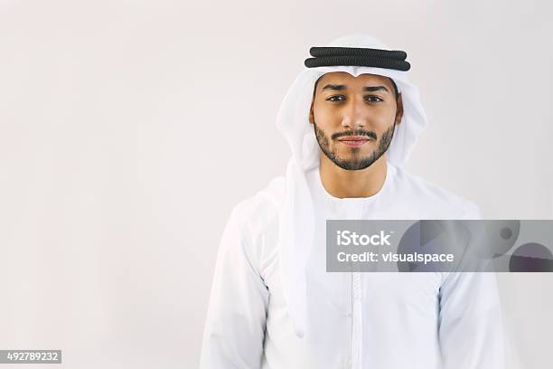 Content Young Arab Man In Traditional Clothing Stock Photo - Download Image Now - Men, United Arab Emirates, Arabia