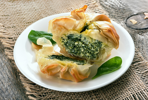 Vegetarian spinach pie on white plate