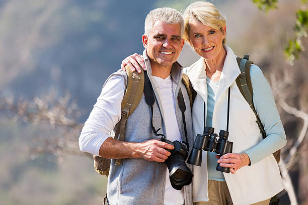 istock middle aged couple hugging in mountain 492789580