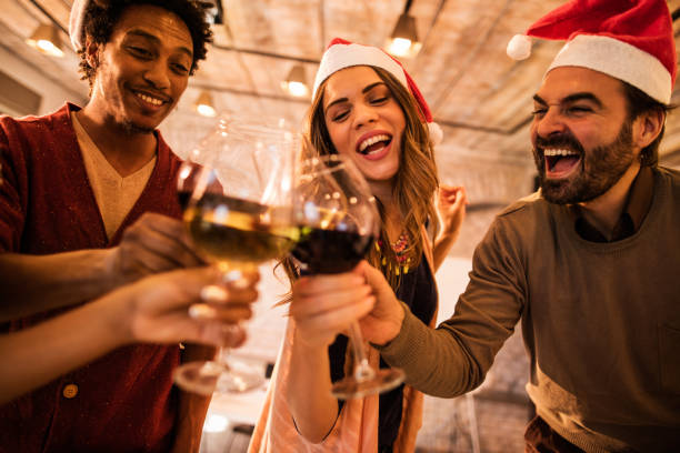istock Cheerful friends having fun while toasting with wine at Christmas. 492789586