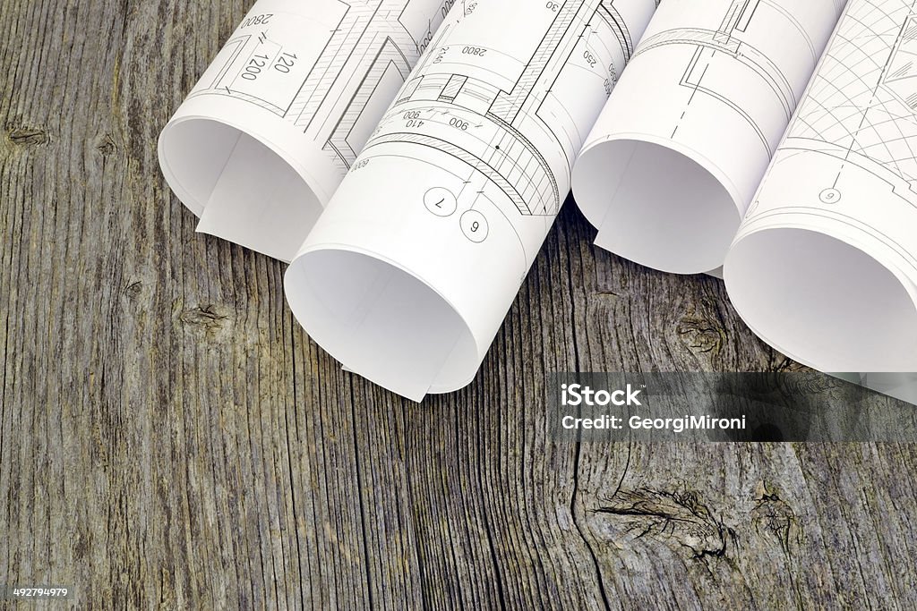 Project drawings on the background of wooden boards Image of several drawings for the project engineer jobs Angle Stock Photo