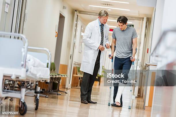 Doctor And Patient In Hospital Stock Photo - Download Image Now - Physical Injury, Hospital, Crutch