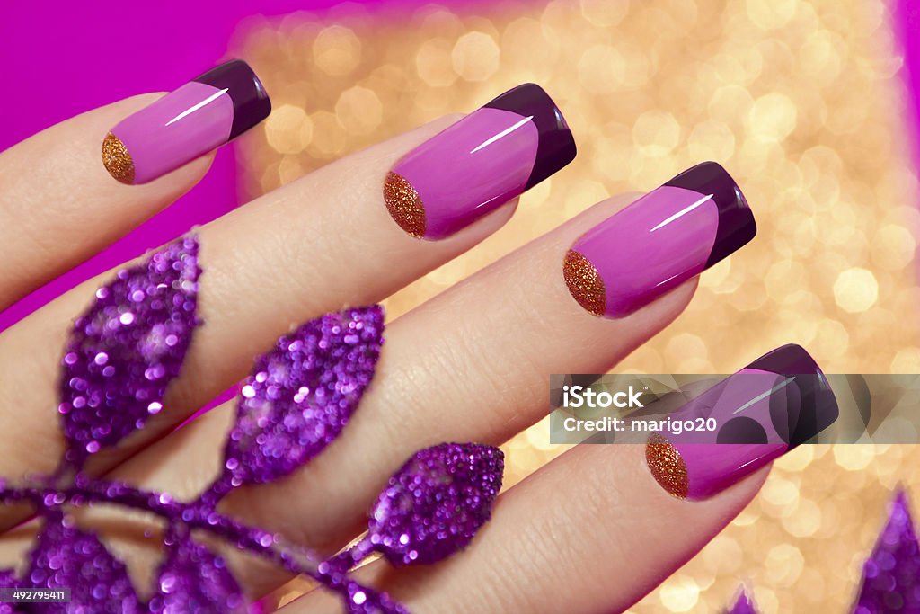 Two-tone French manicure. Two-tone French manicure pink and purple colors for brilliant background with decorative sheet. Fingernail Stock Photo