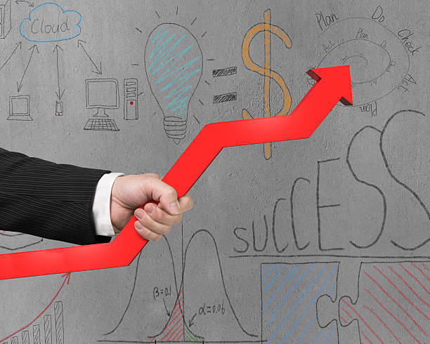 istock Holding red arrow with business doodles on wall 492795881