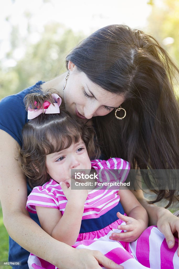 Loving Mother Consoles Crying Baby Daughter Mixed Race Loving Mother Consoles Her Crying Baby Daughter in Park. Brat Stock Photo