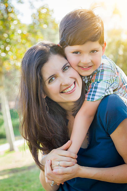 istock Attractive Mixed Race Mother and Son Hug in Park 492796145
