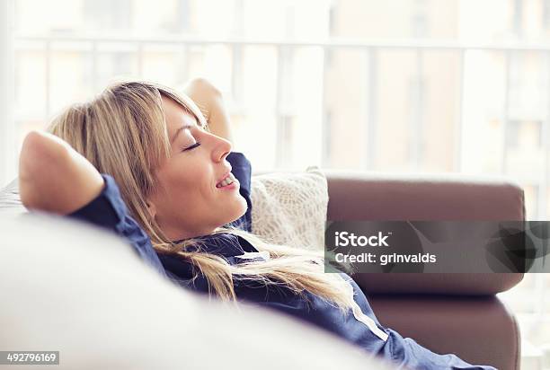 Relaxed Young Woman Stock Photo - Download Image Now - Comfortable, Sofa, Eyes Closed