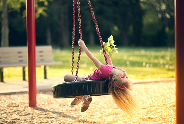 istock Little girl swinging on swing. 492797455