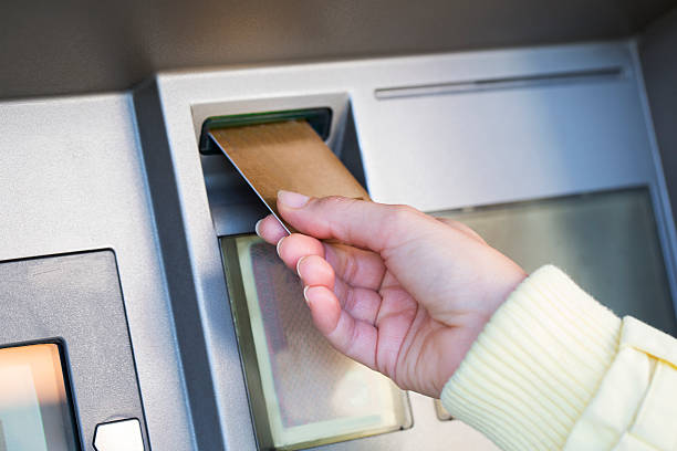 istock Woman's hand putting credit card into ATM cash machine 492798245