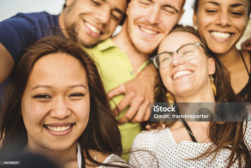 Group of friends laughing and doing a selfie Adolescence Stock Photo