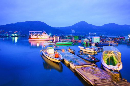 Floating village and moored boats at dusk near Sok Kwu wan village, Hong Kong.