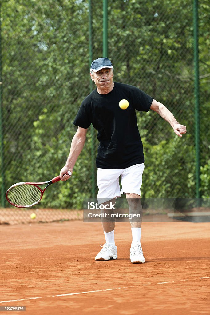 Active senior man playing tennis Active senior man playing tennis in his 70s 70-79 Years Stock Photo