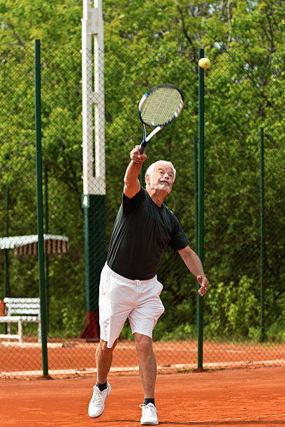 istock Senior tennis player serving 492799881