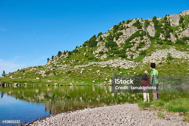 Mother And Daughter On Lake Shore Stock Photo - Download Image Now - Child, Trentino-Alto Adige, 2015