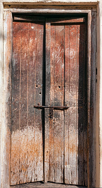 istock Old dilapidated wooden door. 492805374