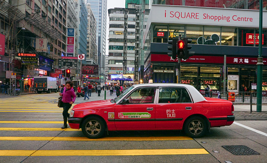 Hong Kong, China - December 26, 2014: Taxis running on the street in Hong Kong. Over 90% daily travellers use public transport. Its the highest rank in the world.