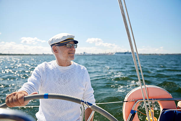 istock senior  man at helm on sailing boat in sea 492806626